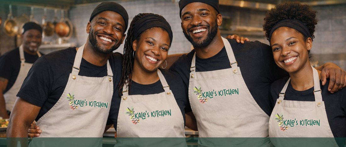 The smiling Kale's Kitchen team in branded aprons